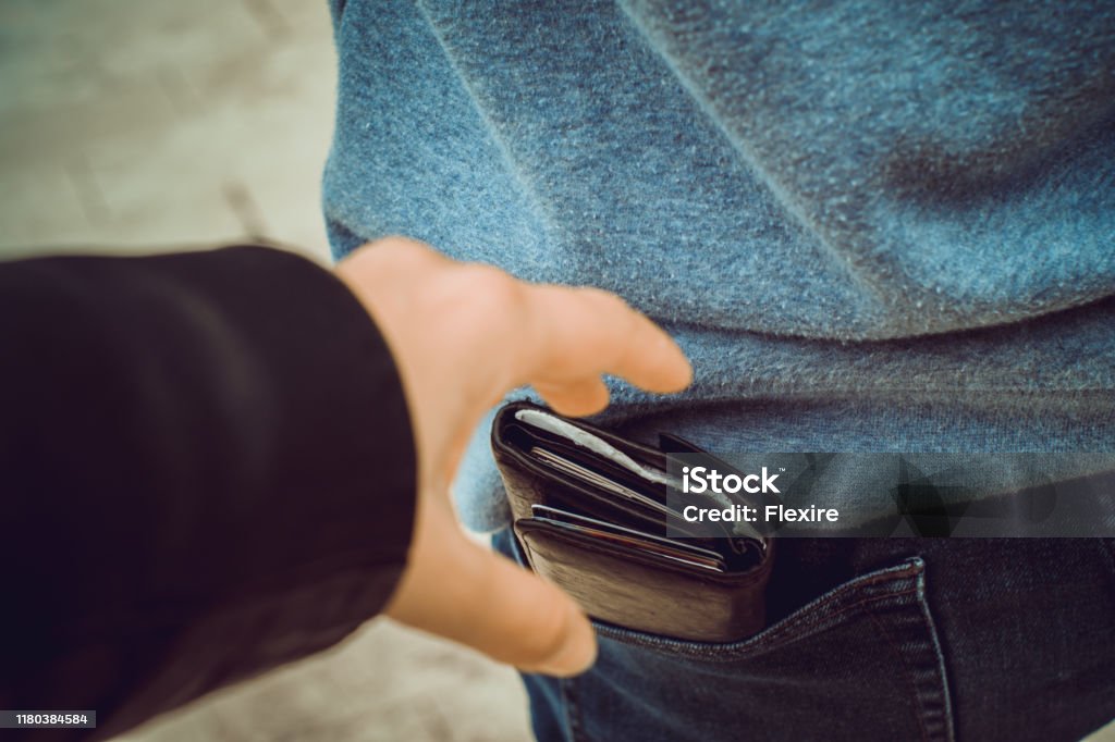 one hand reaches for a purse in the back pocket